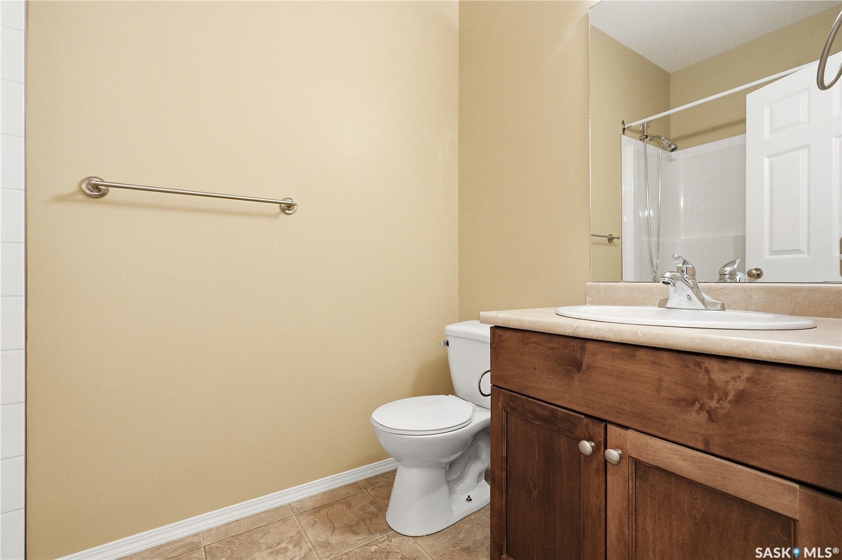 Wood-finish vanity with a single basin sink, chrome faucet, and integrated countertop