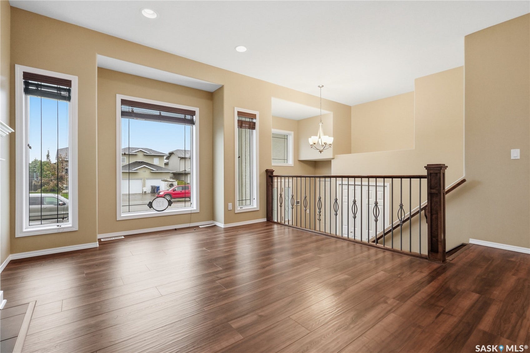 Wood-finish flooring throughout, recessed lighting, and multiple windows