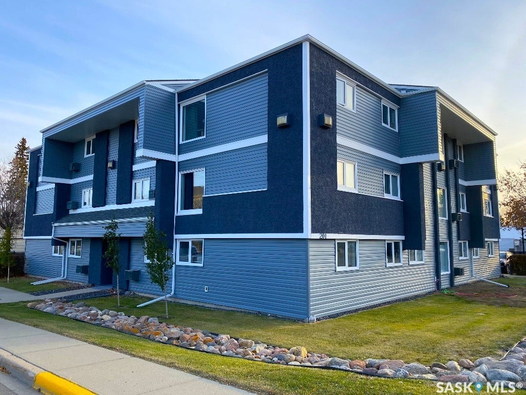 Multi-level building exterior featuring a combination of horizontal siding and textured stucco finishes
