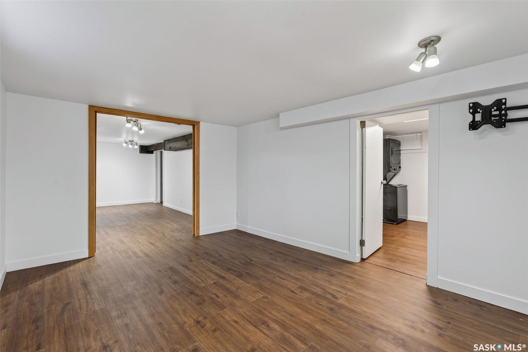 Wood-finish flooring throughout, with white painted walls and trim