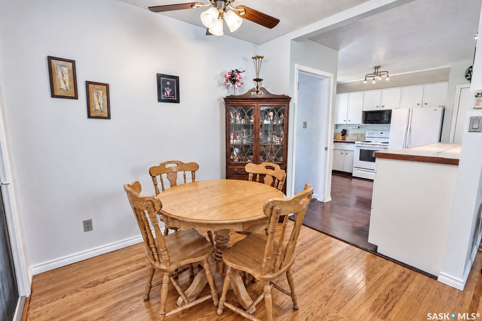 Wood-finish flooring throughout, with a ceiling fan with integrated lighting