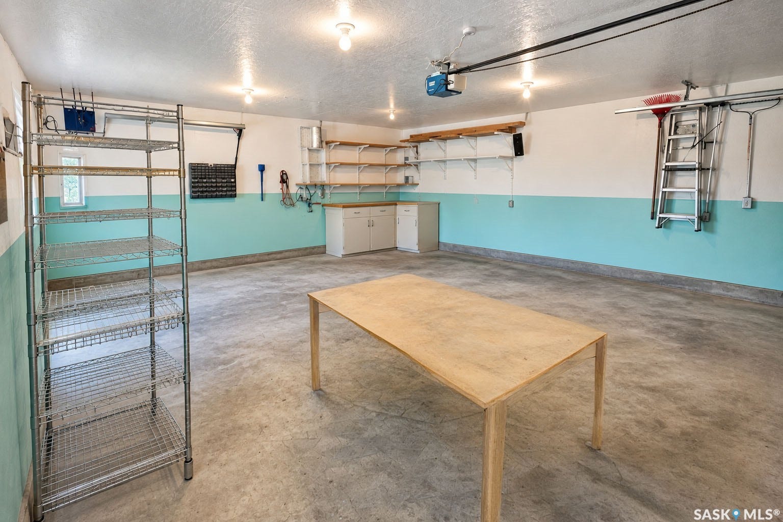 Polished concrete flooring, recessed lighting, built-in shelving, work surface, and cabinetry