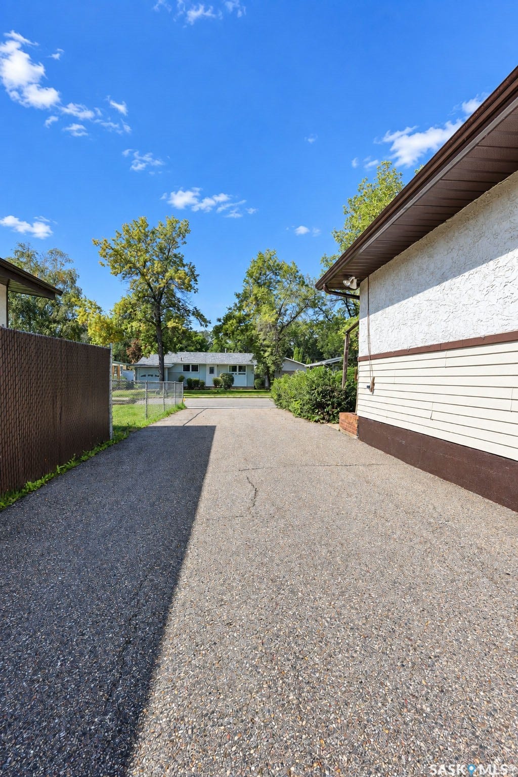 Property exterior featuring textured stucco siding and horizontal panel siding