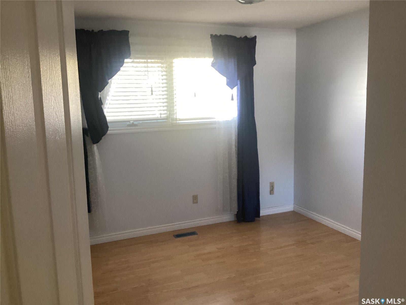 Light wood-finish flooring with crisp white walls