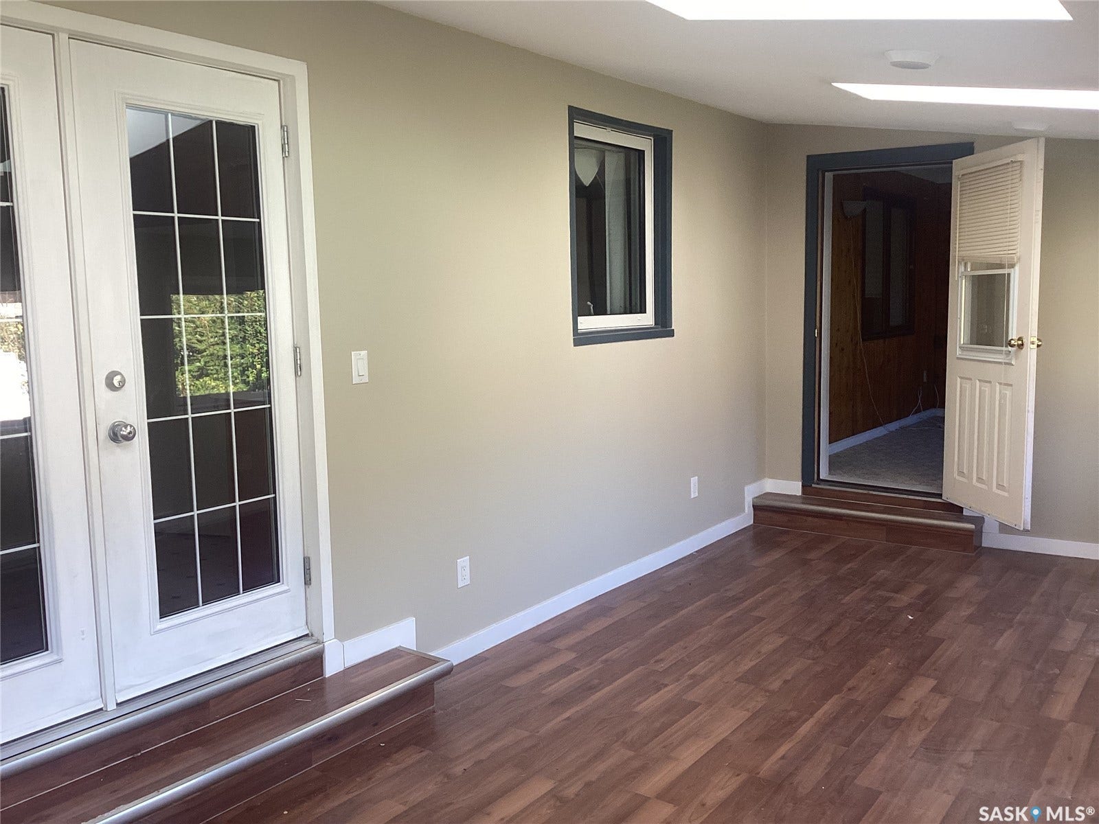 Wood-finish flooring, dual skylights, and white trim