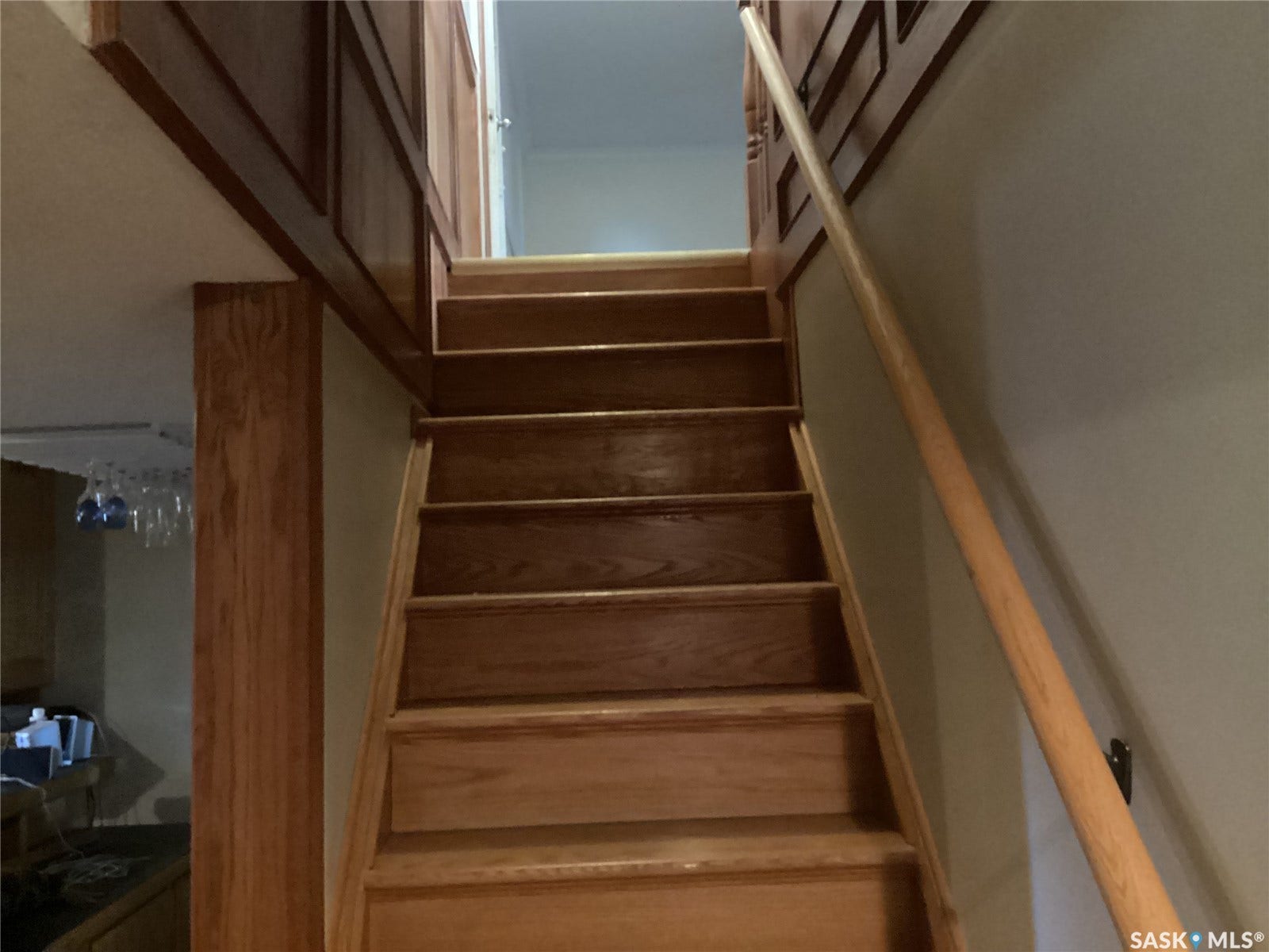 Wood-finish staircase with a matching wood handrail