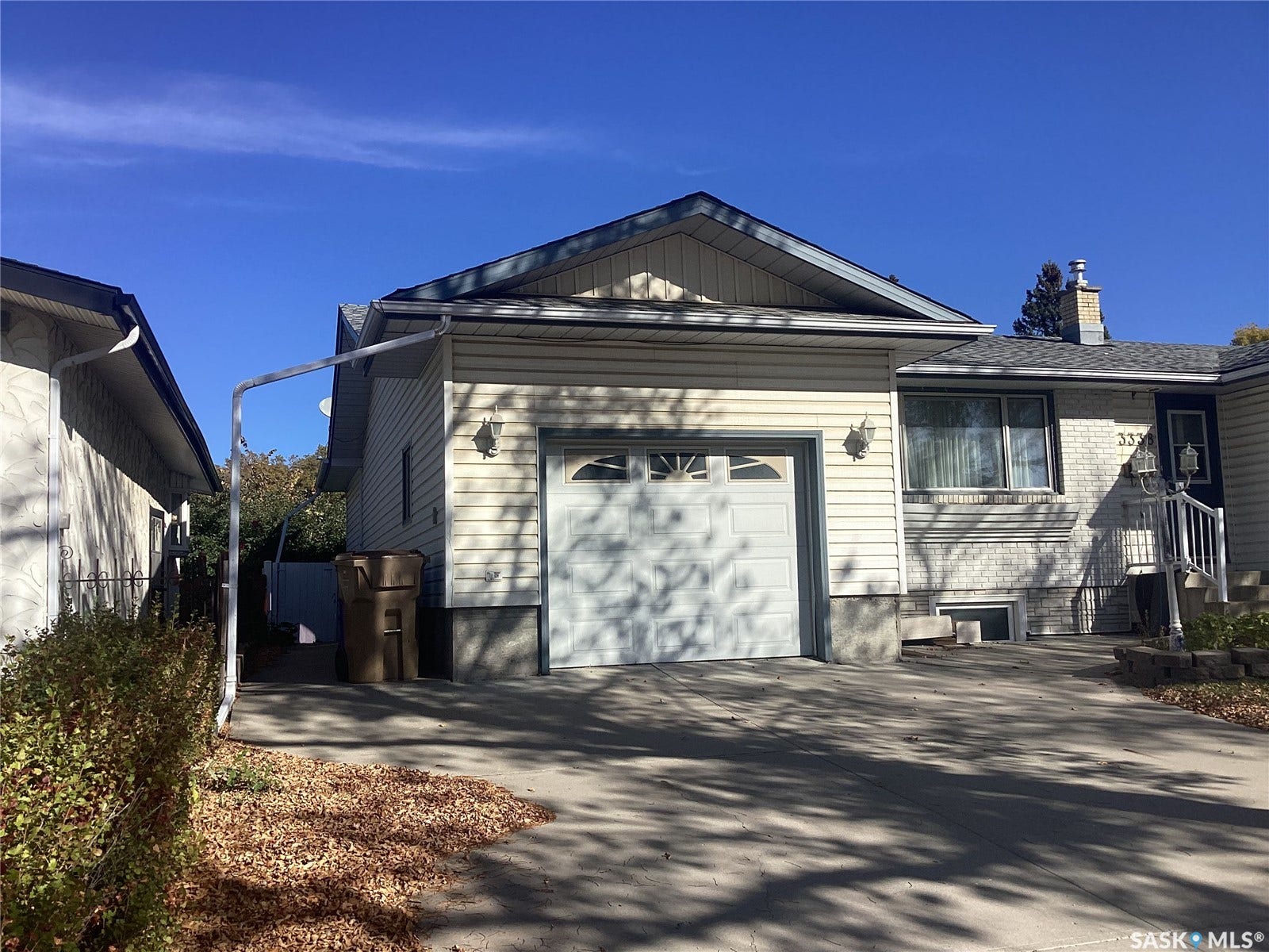 Attached single-car garage with a concrete driveway
