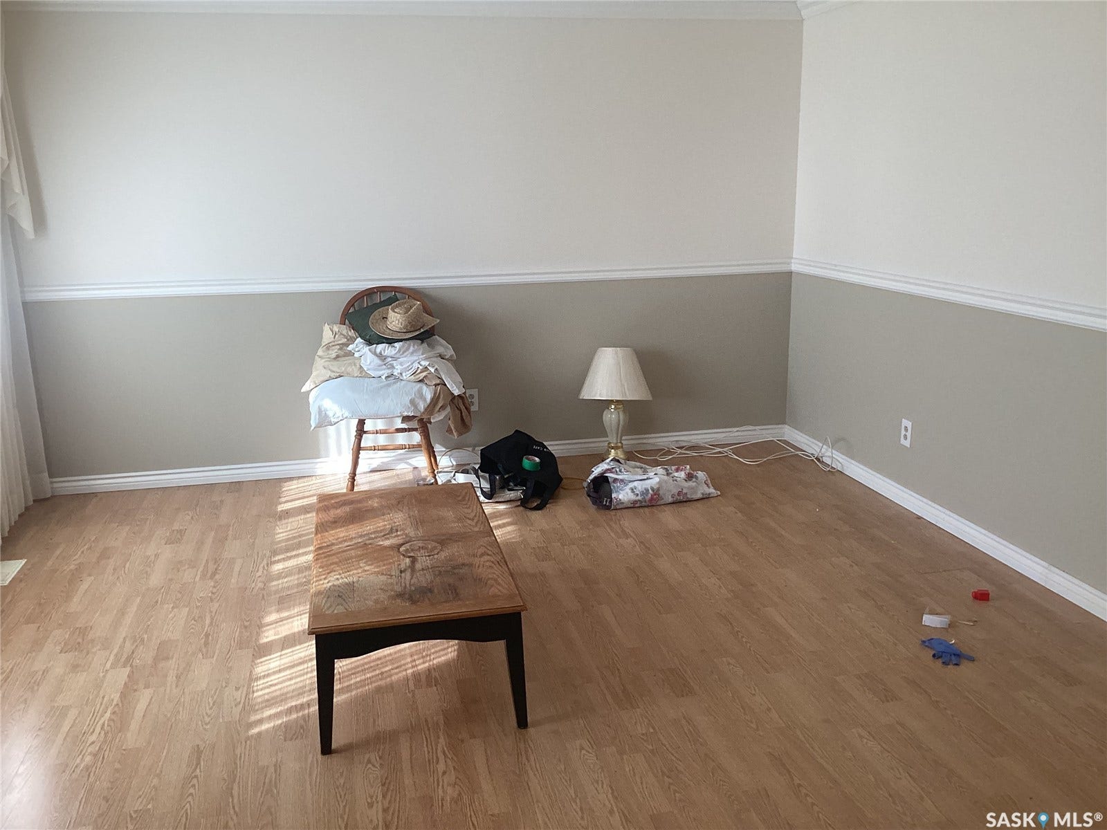 Wood-finish flooring throughout, two-tone wall paint, and white crown molding