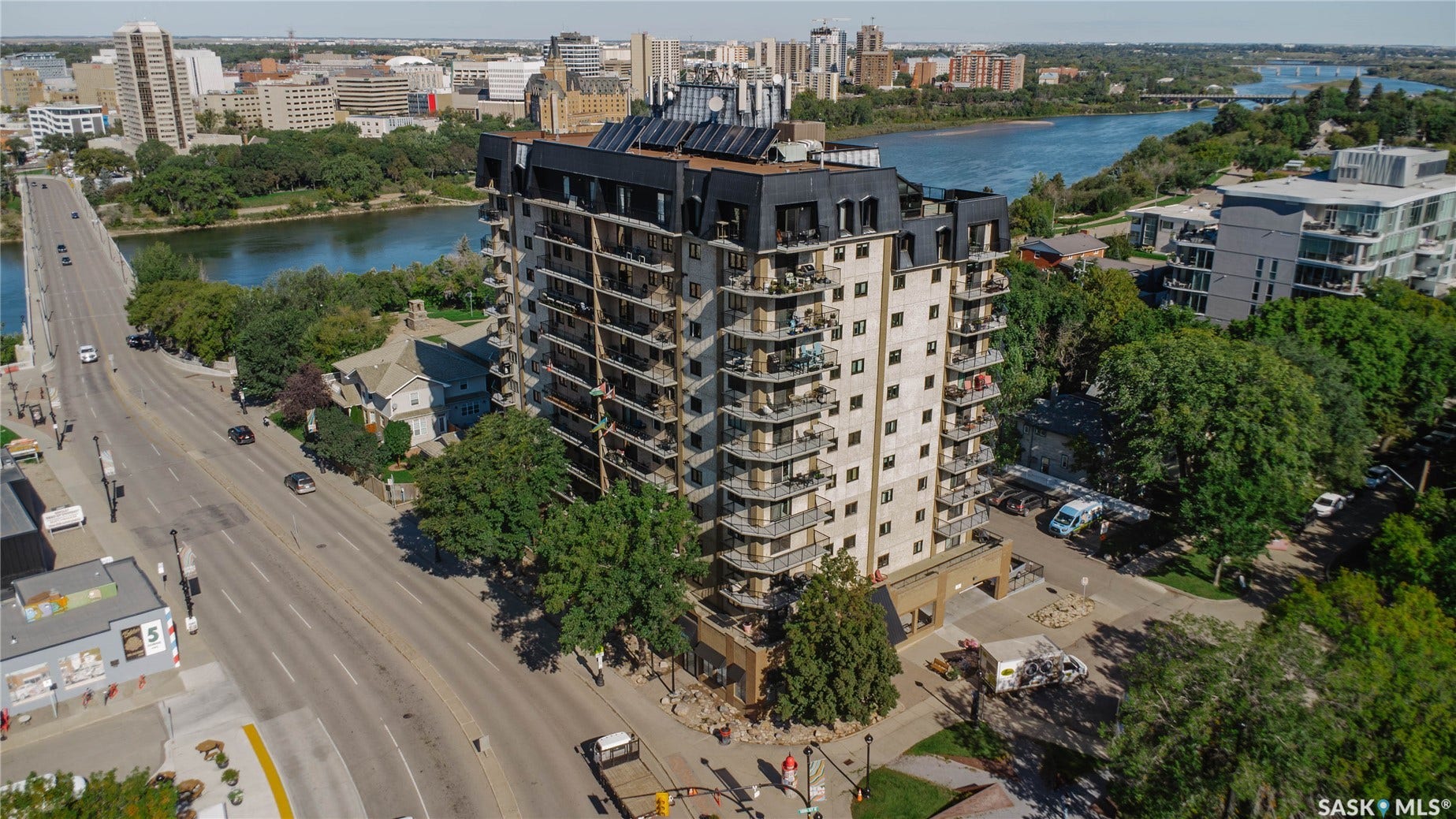 Multi-story residential building with private balconies and a flat roofline