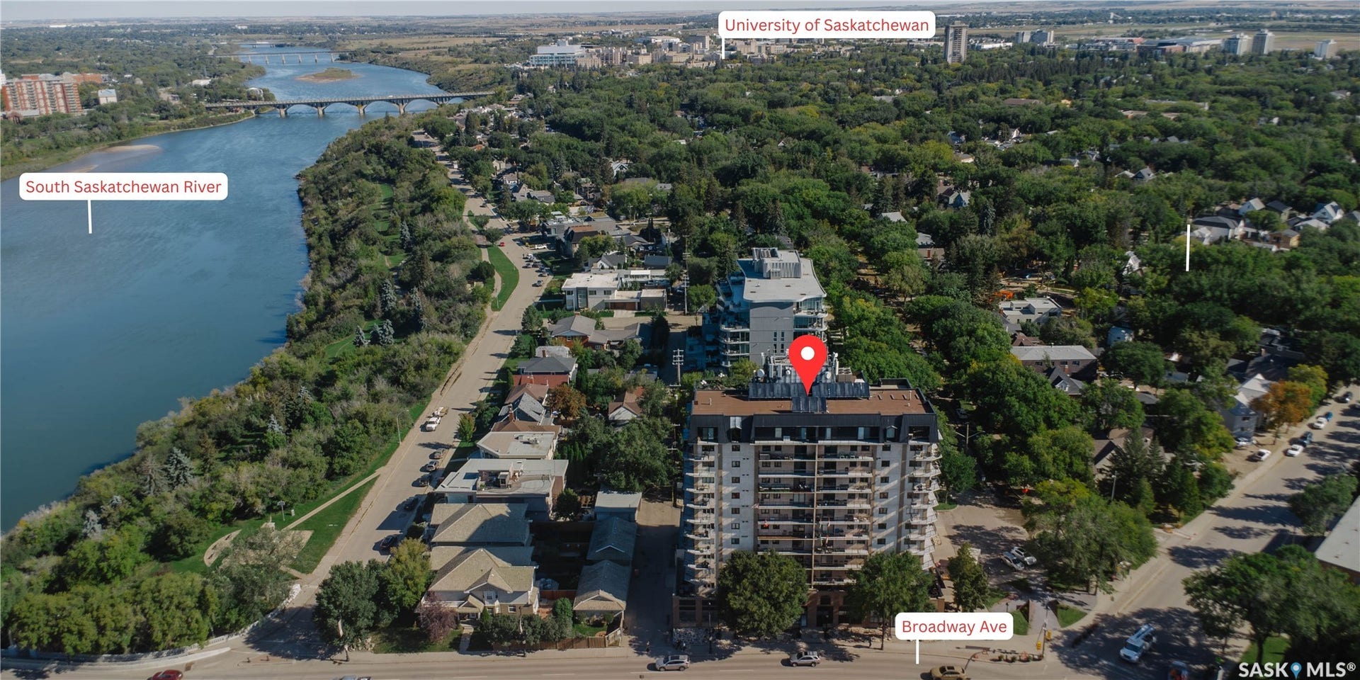 High-rise building with multiple balconies, positioned near Broadway Avenue and the South Saskatchewan River