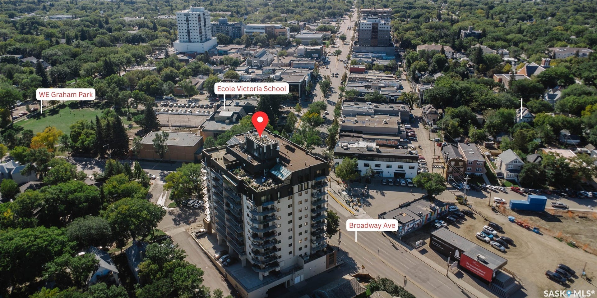 Multi-story residential building featuring multiple balconies and a rooftop structure