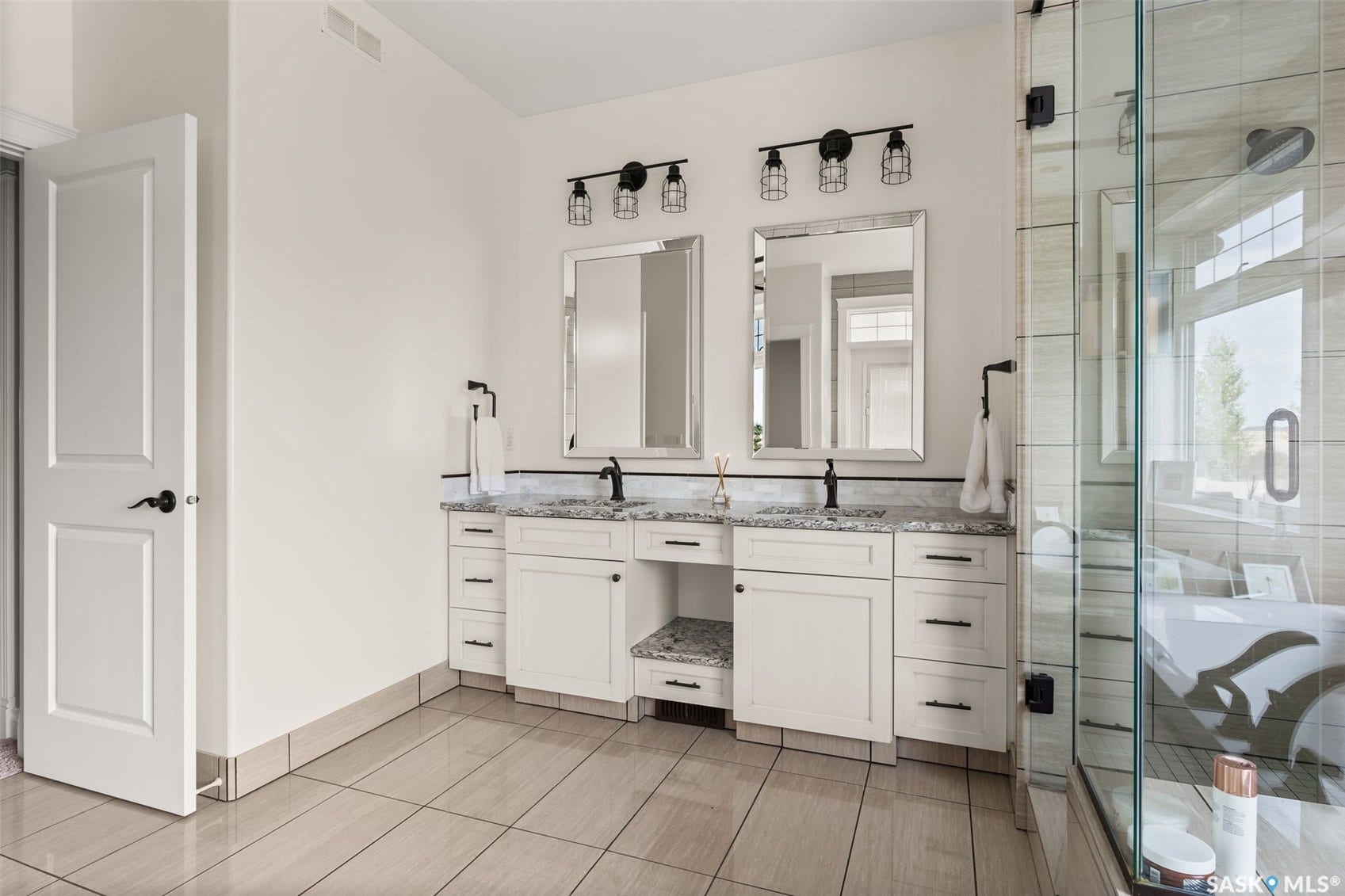 Dual vanity with granite countertops, undermount sinks, and matte black fixtures