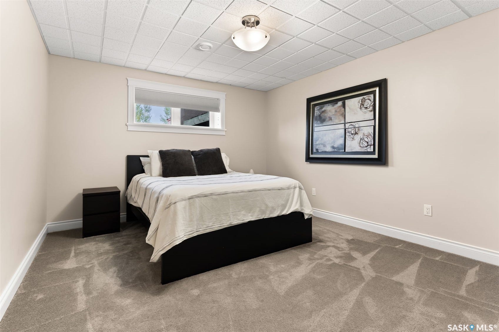 Neutral-toned walls, recessed lighting, and a window with white trim