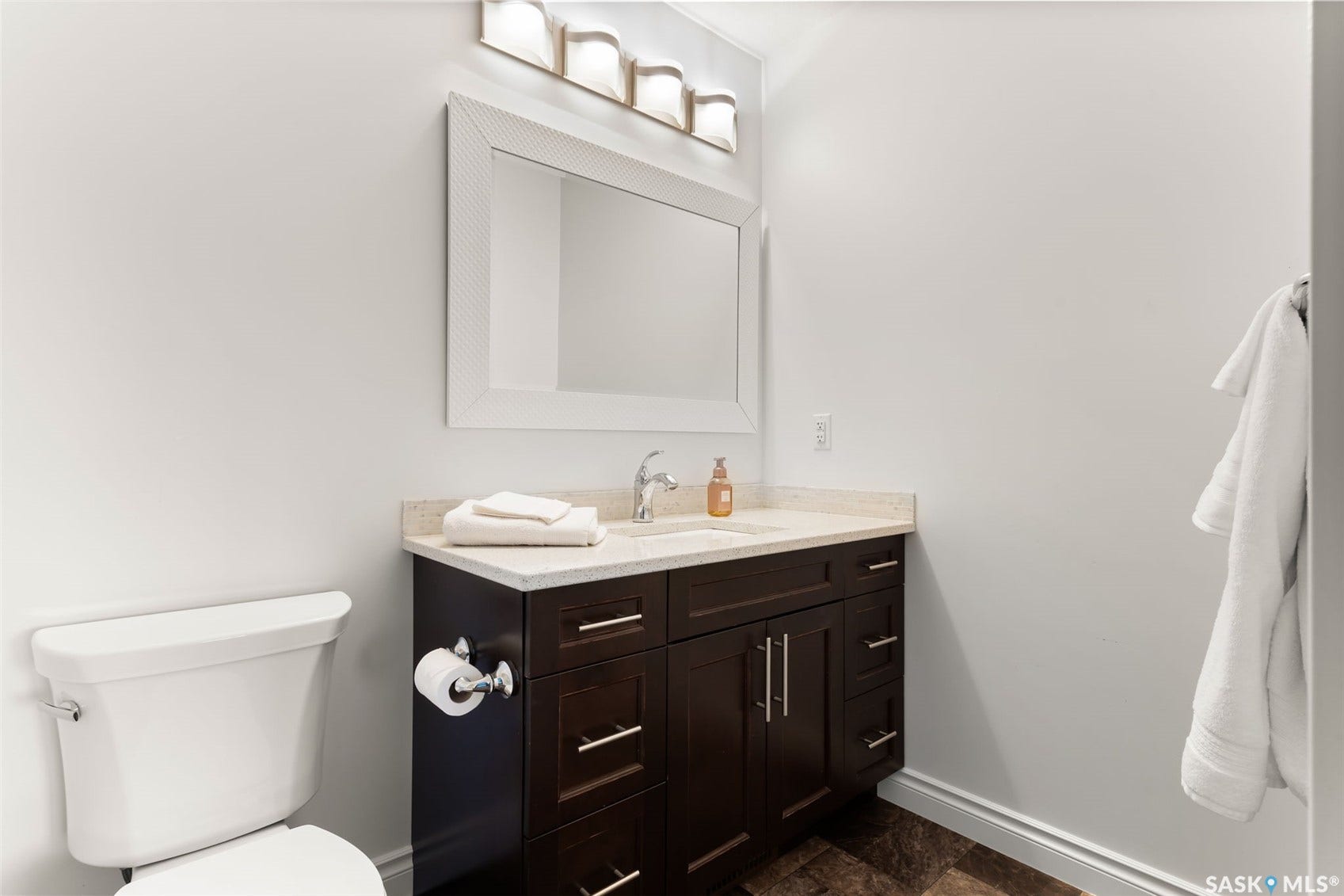 Dark wood-finish vanity with a light-toned countertop