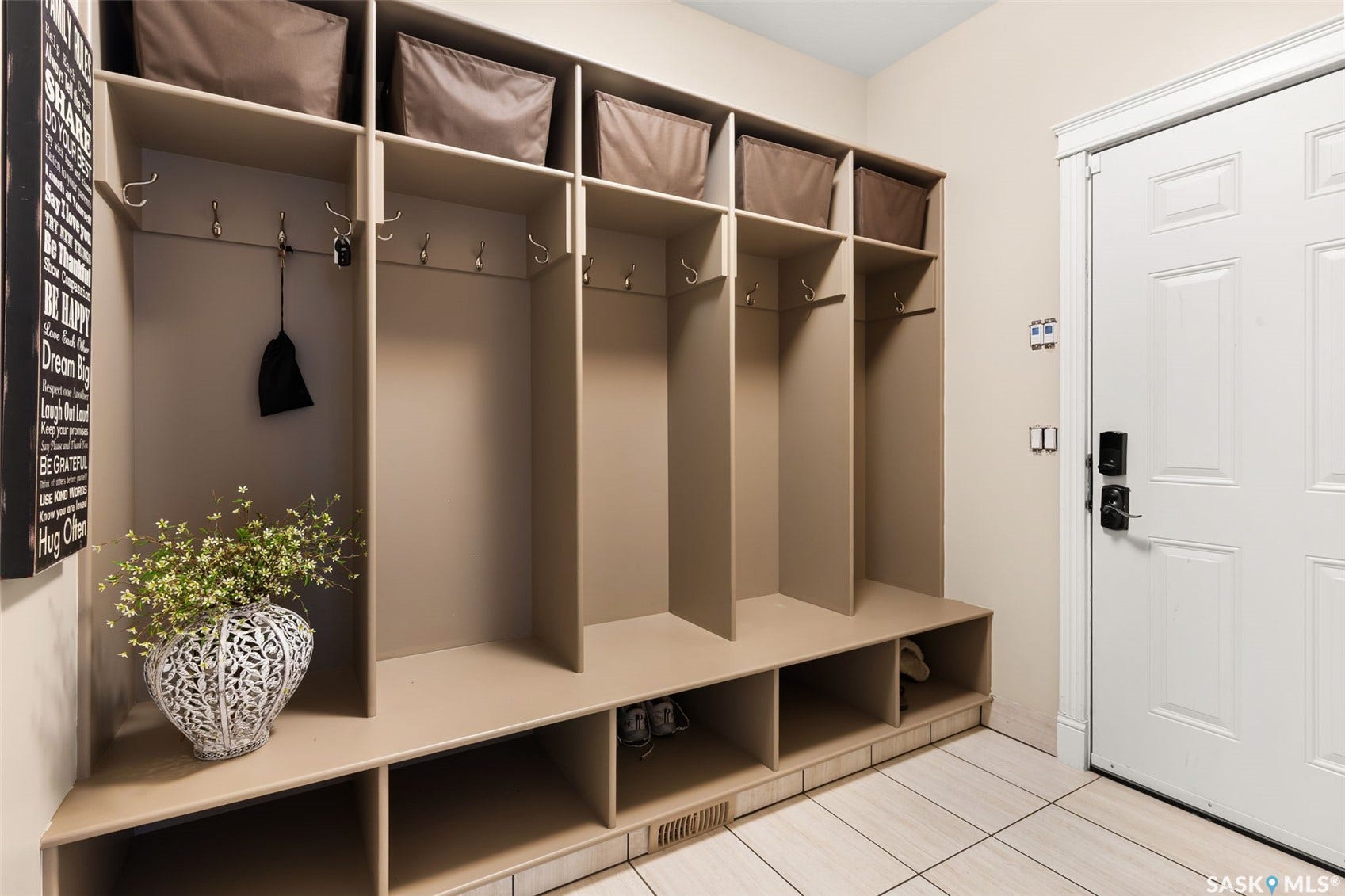 Built-in mudroom storage system with individual compartments, upper shelving, and lower cubbies