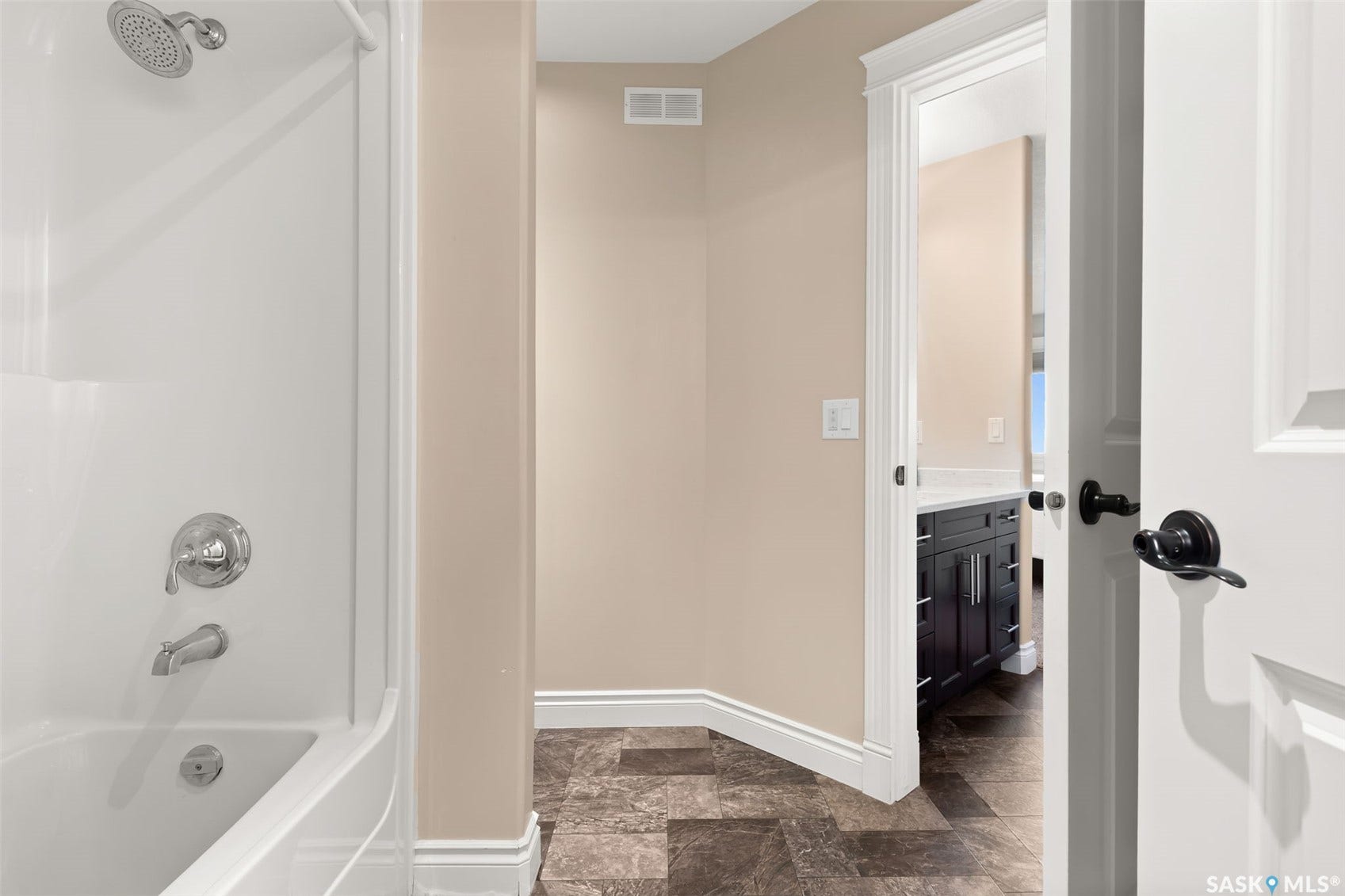 White shower and tub combination with chrome fixtures