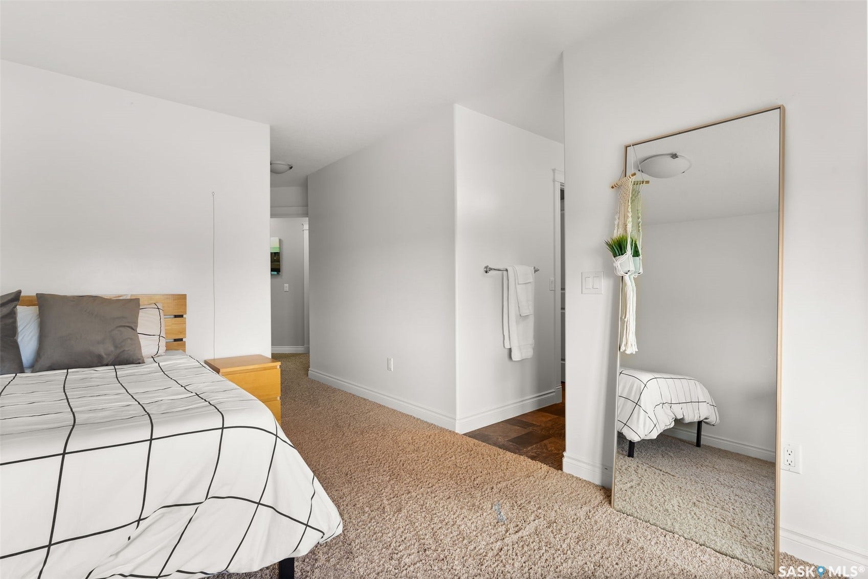 Carpeted flooring, white walls, and a light-toned wood headboard