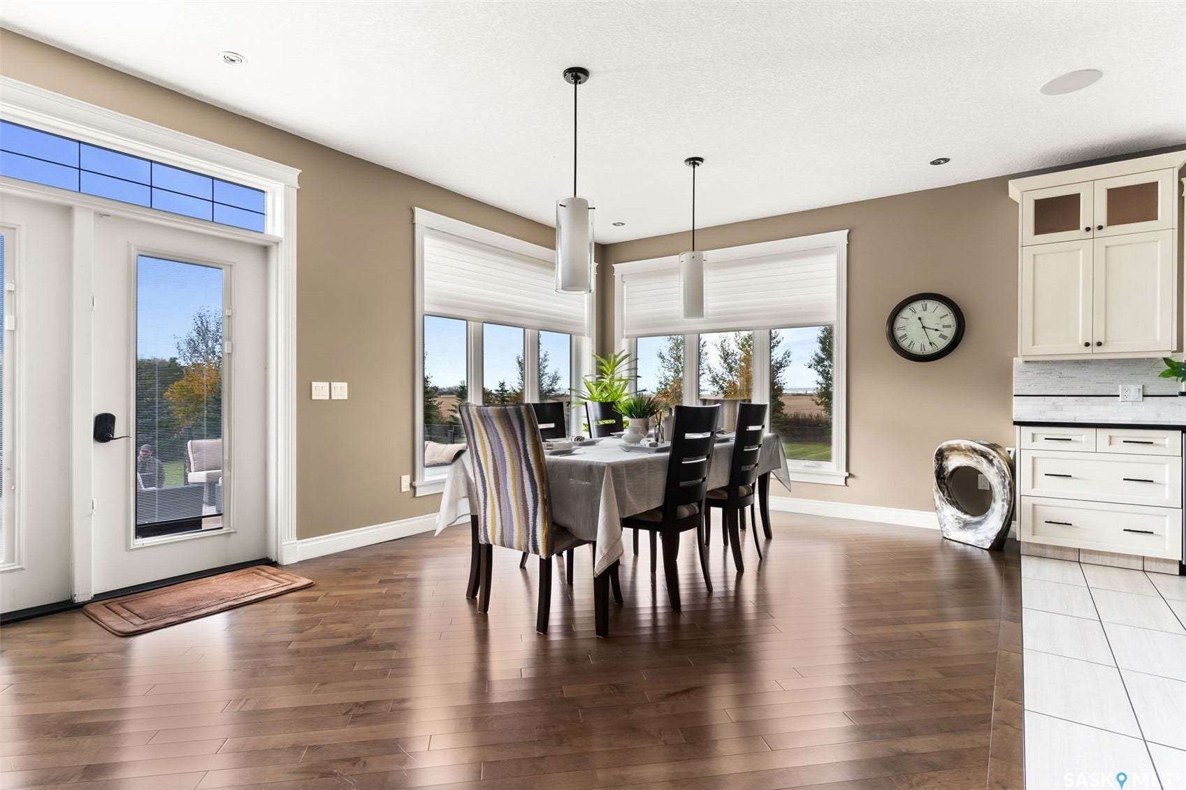 Hardwood flooring, French doors with transom windows, recessed lighting, pendant lighting, and built-in cabinetry