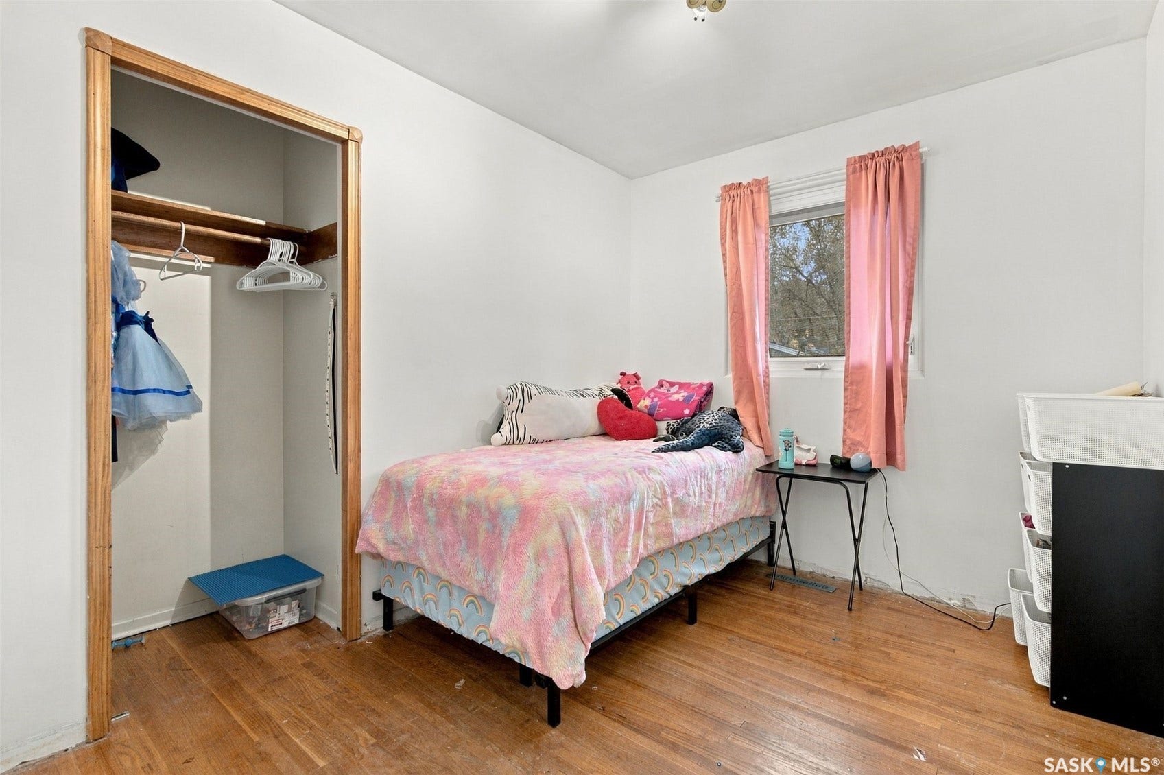 Wood-finish flooring, white walls, and a window with natural light