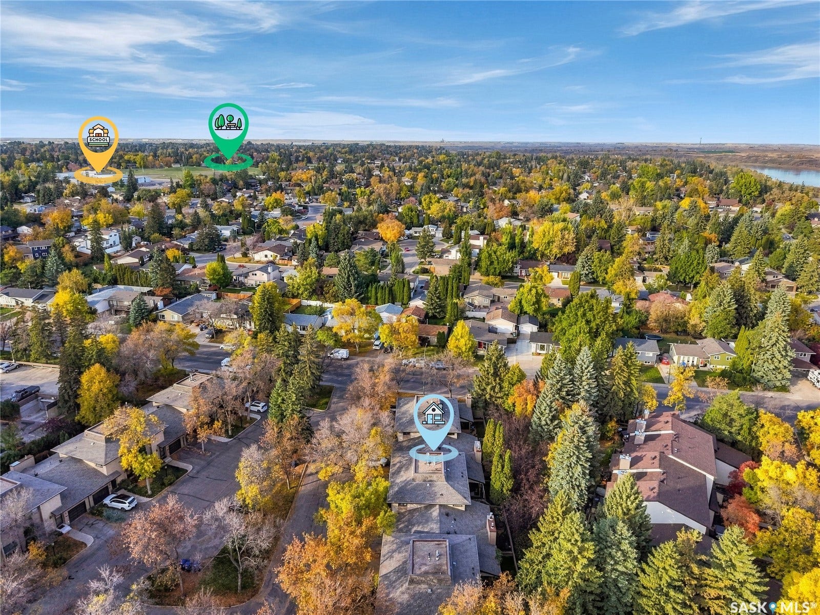 Expansive residential area with a prominent river and abundant mature trees