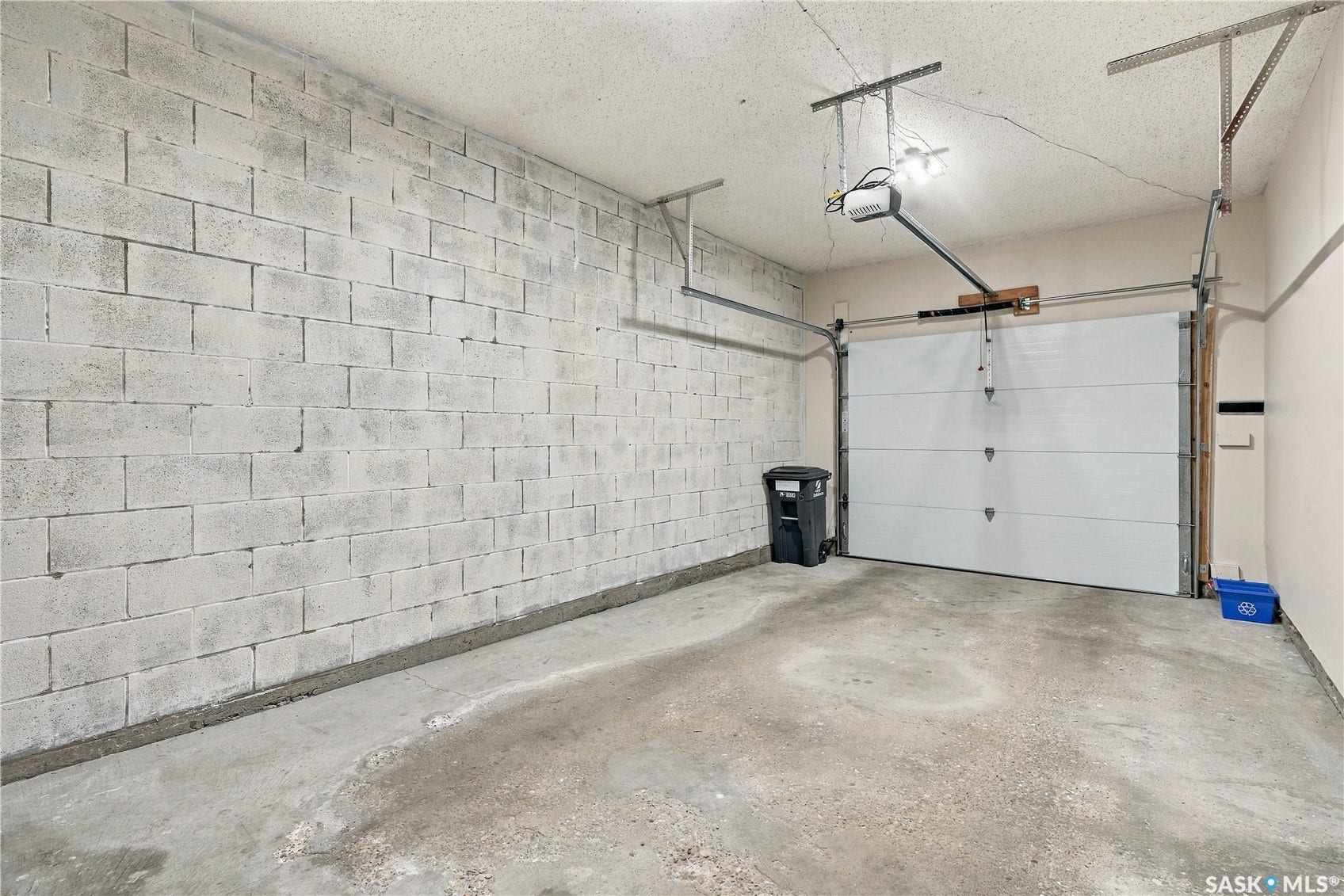 Concrete block wall with a single overhead garage door