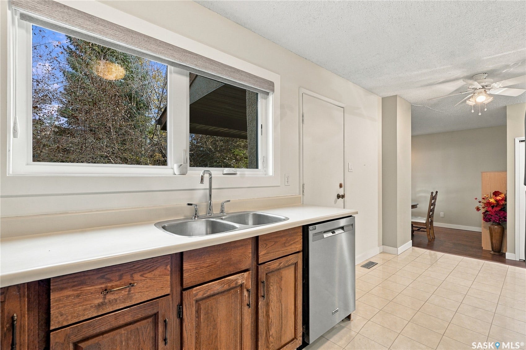 Dual basin stainless steel sink with a chrome faucet, set into a light-toned countertop