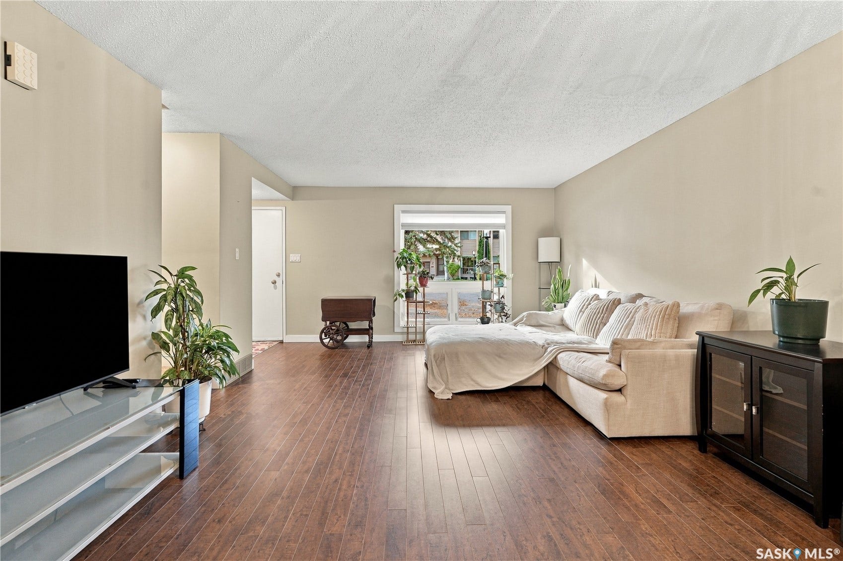 Wood-finish flooring, neutral wall tones, and a window with natural light