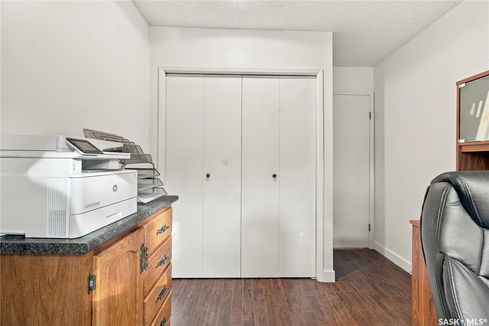 Wood-finish flooring with white baseboards