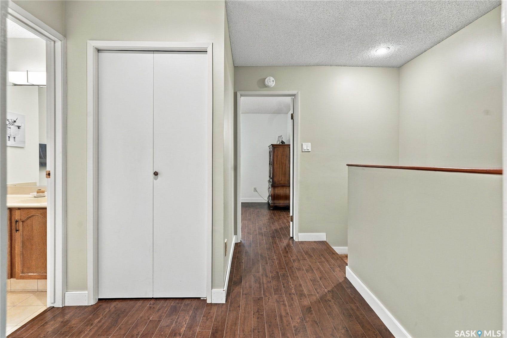 Wood-finish flooring throughout, complemented by a white bi-fold closet door