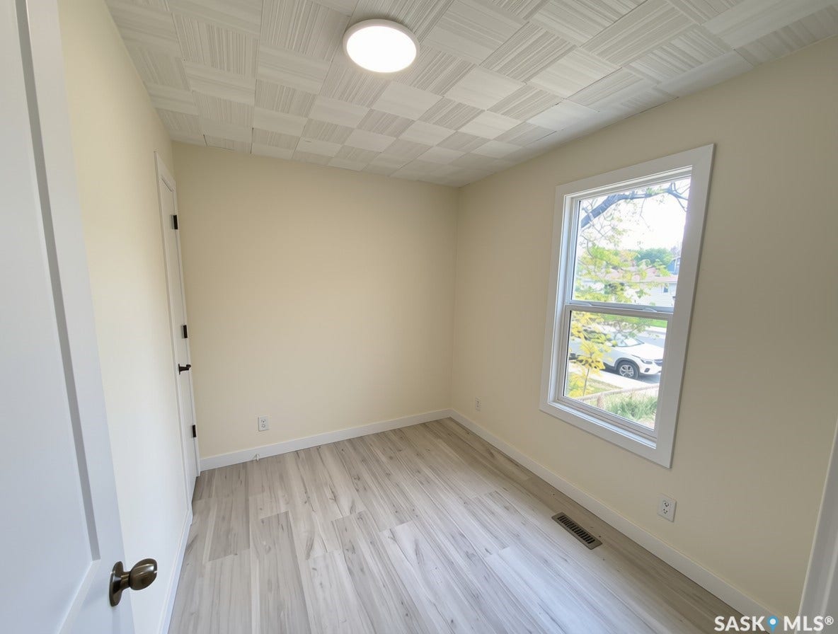 Ceiling light fixture, patterned ceiling,new vinyl plank flooring, white trim, and a window with outdoor scenery