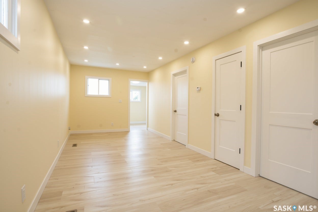 New recessed ceiling lighting, vinyl plank flooring, multiple windows, and paneled interior doors