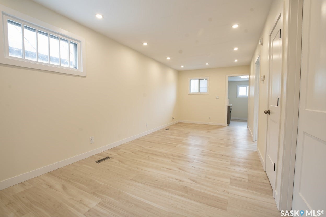 New recessed lighting, vinyl plank flooring, white trim, and white doors