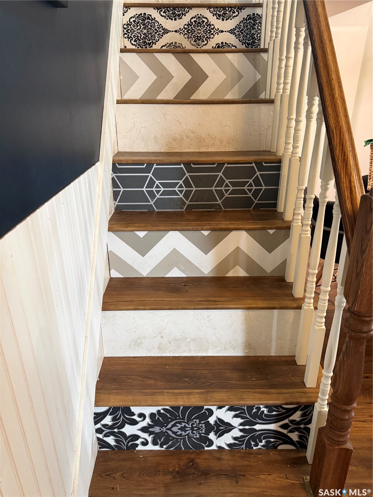 Staircase featuring wood-finish treads and patterned risers