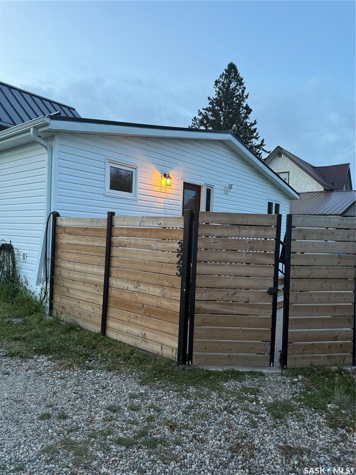 White vinyl siding with a dark metal roof