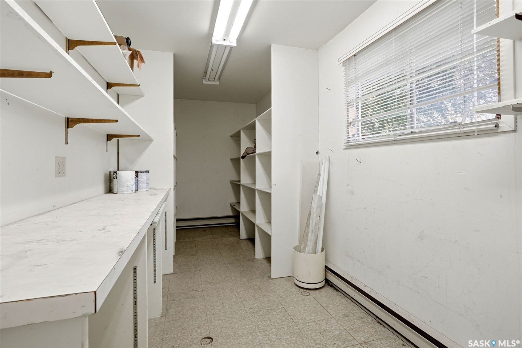 3361 Wascana Street, Regina SK S4S 2H2 White built-in shelving, extensive counter space, and a window with blinds