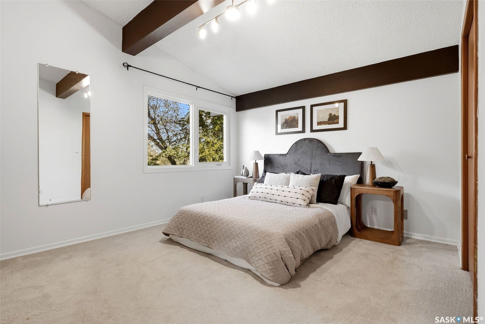 3361 Wascana Street, Regina SK S4S 2H2 Vaulted ceiling with exposed beams, light-colored carpeting, and a large window