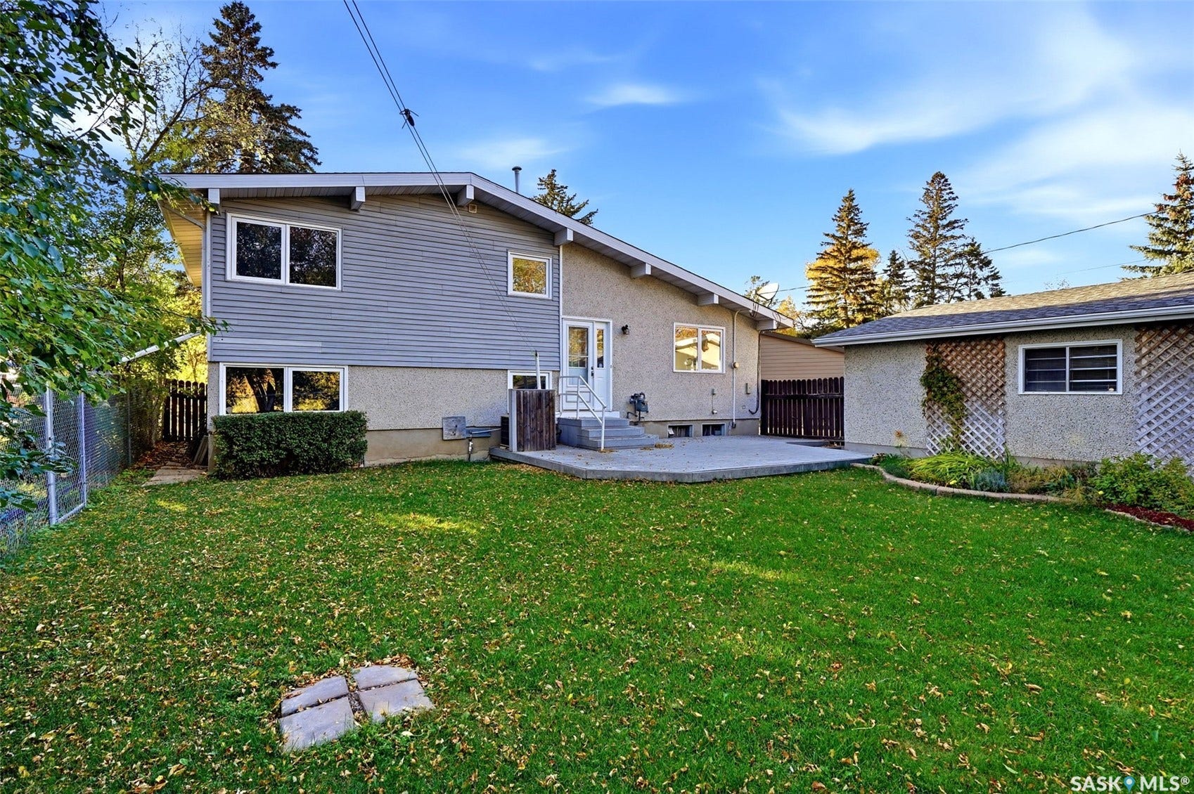 3361 Wascana Street, Regina SK S4S 2H2 Expansive green lawn with a concrete patio