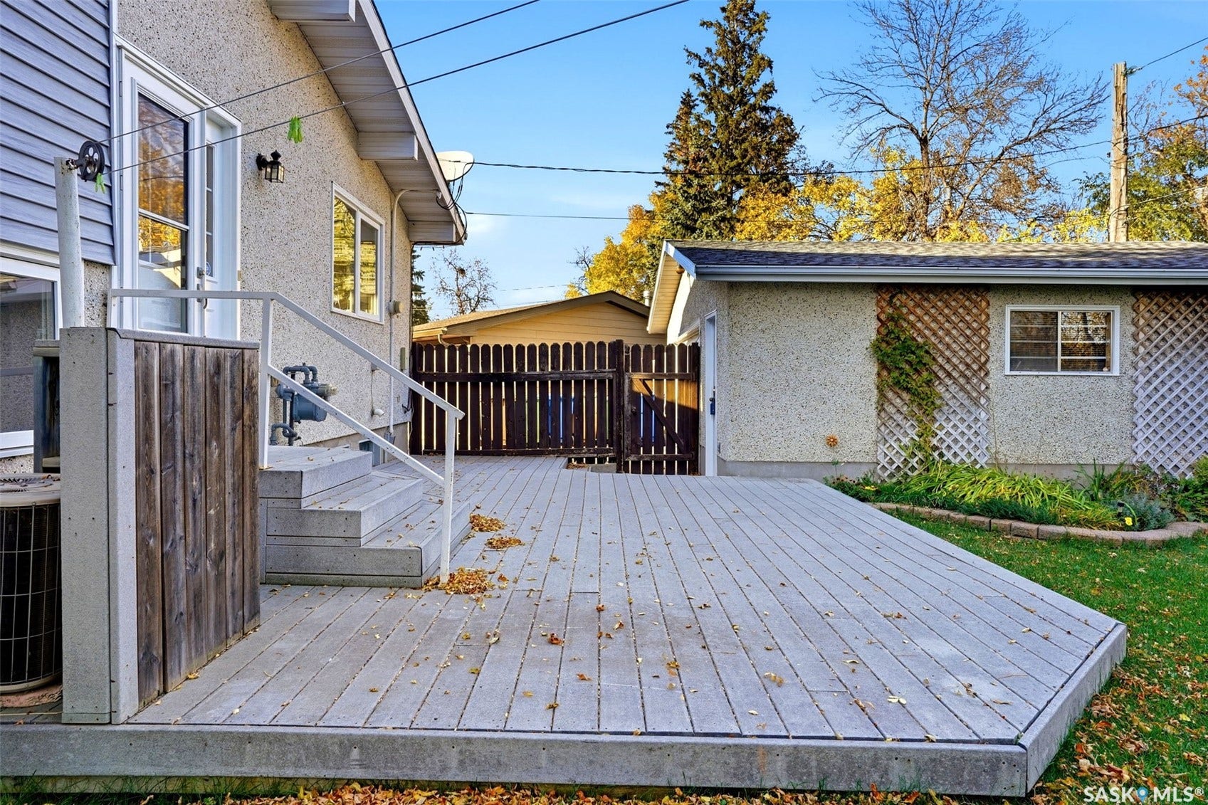 3361 Wascana Street, Regina SK S4S 2H2 Expansive outdoor deck with integrated steps and white railings