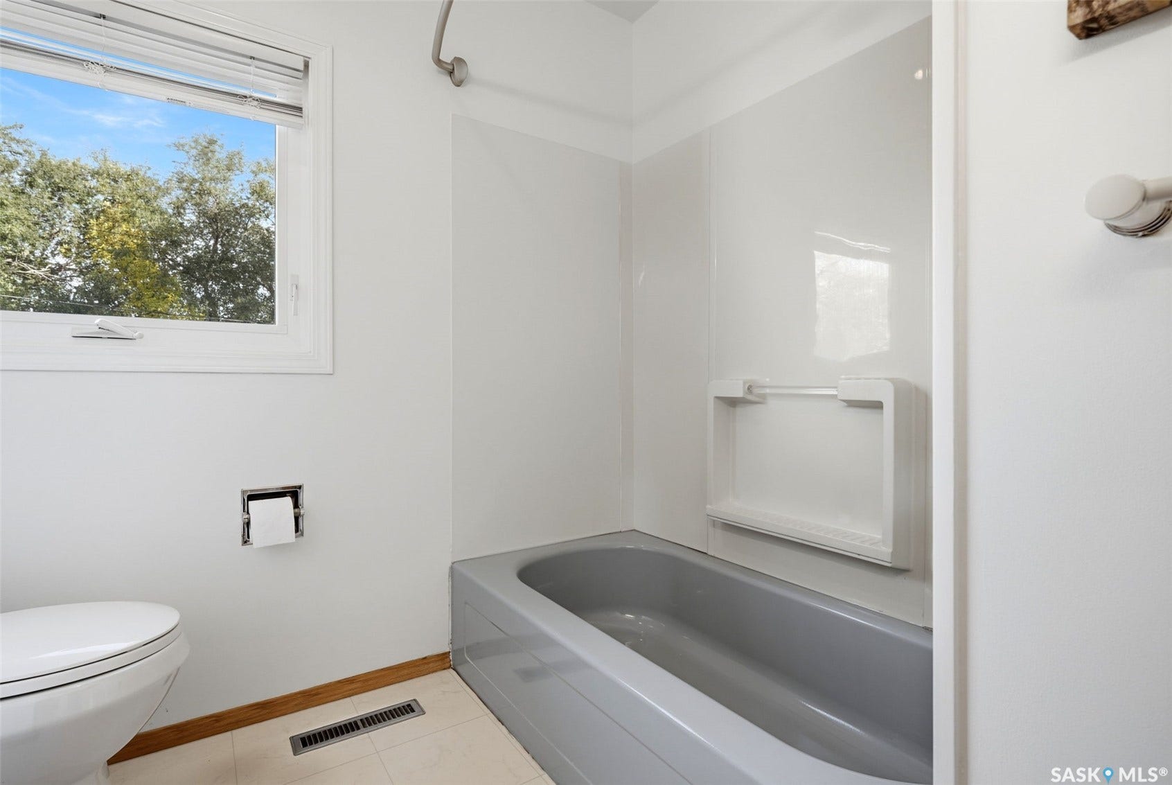 3361 Wascana Street, Regina SK S4S 2H2 White window frame with a clear glass pane, a gray bathtub, a white shower surround, and a white toilet