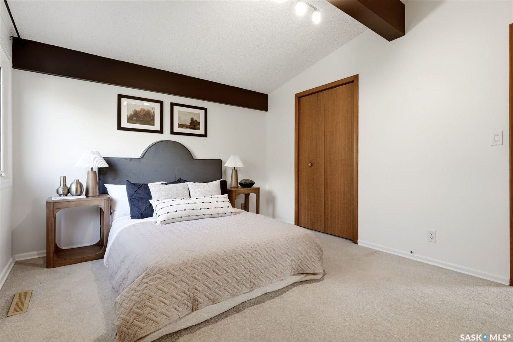 3361 Wascana Street, Regina SK S4S 2H2 Vaulted ceiling with exposed architectural beams, track lighting, and light wood-finish bi-fold closet doors