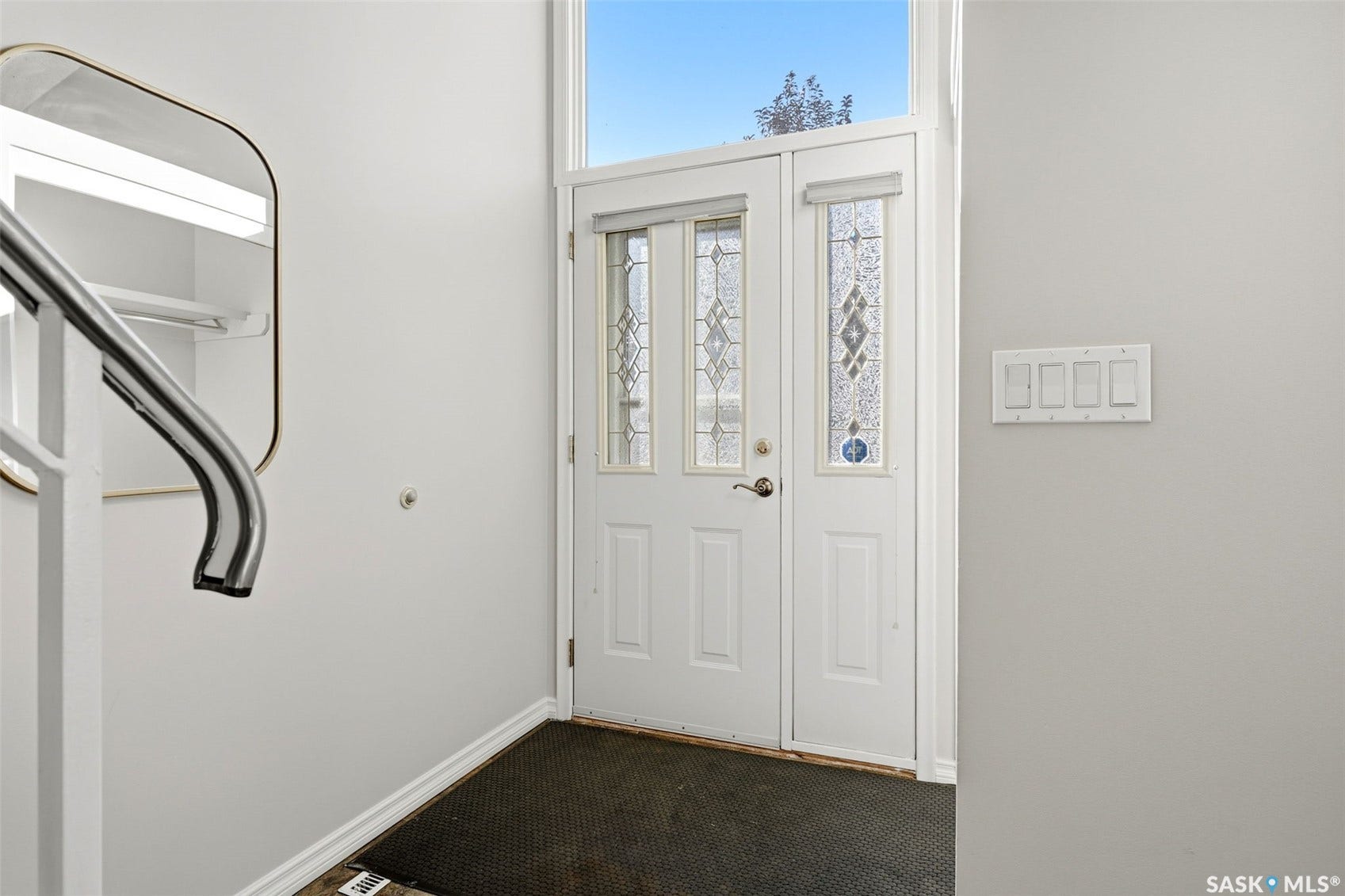 3361 Wascana Street, Regina SK S4S 2H2 Entryway featuring a white door with decorative glass inserts, a coordinating sidelight, and a transom window above