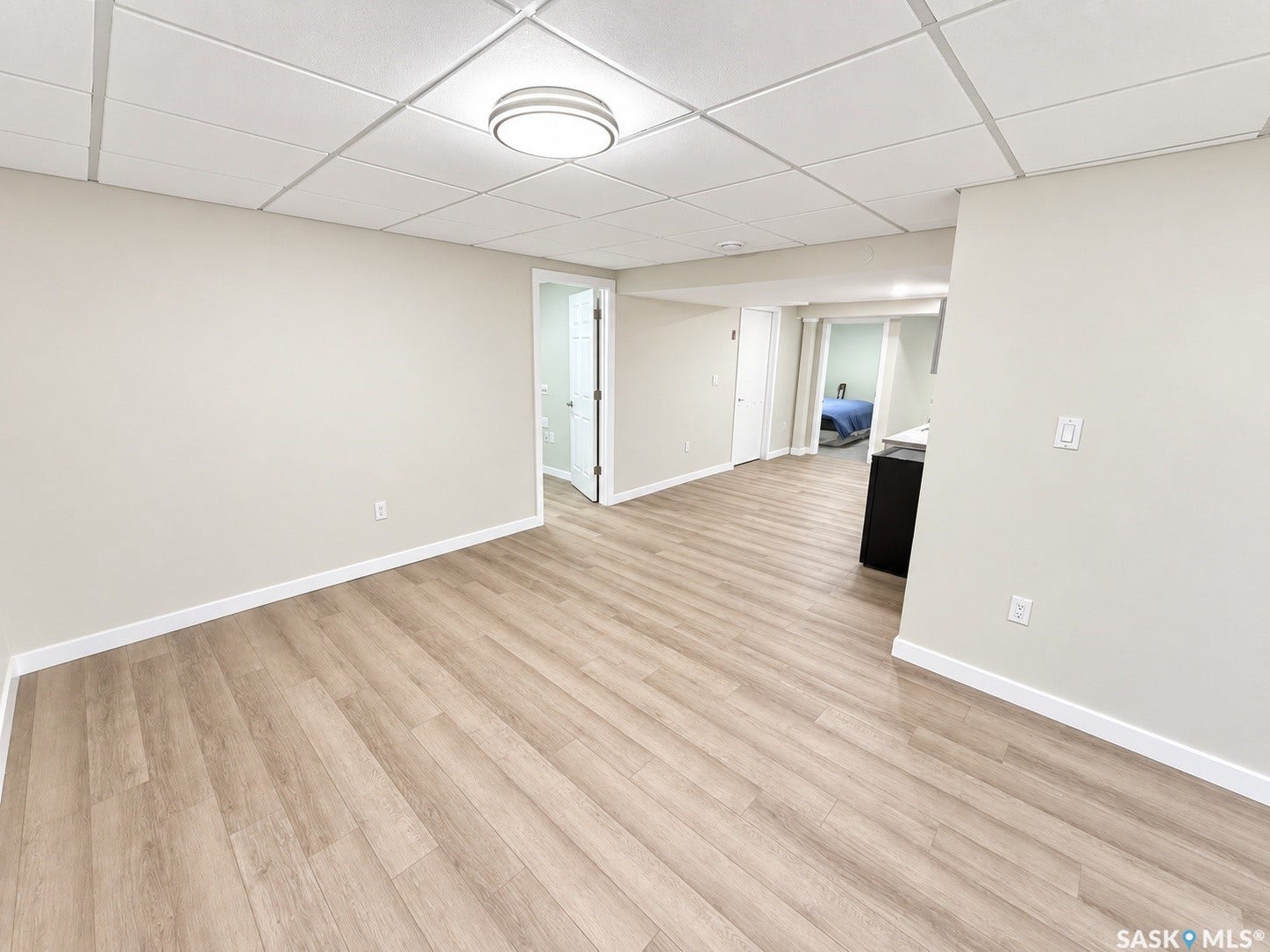 5810 Sherwood Drive, Regina SK S4T 6Y7 Wood-finish flooring, recessed lighting, drop ceiling, and neutral wall tones