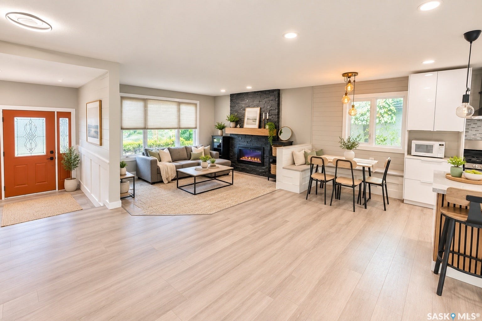5810 Sherwood Drive, Regina SK S4T 6Y7 Light wood-finish flooring throughout, with a decorative fireplace featuring a wood mantel