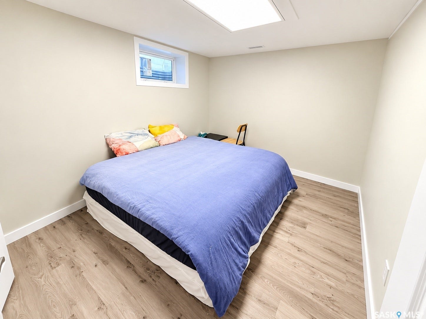 5810 Sherwood Drive, Regina SK S4T 6Y7 Light wood-finish flooring, recessed ceiling light, and a white window frame