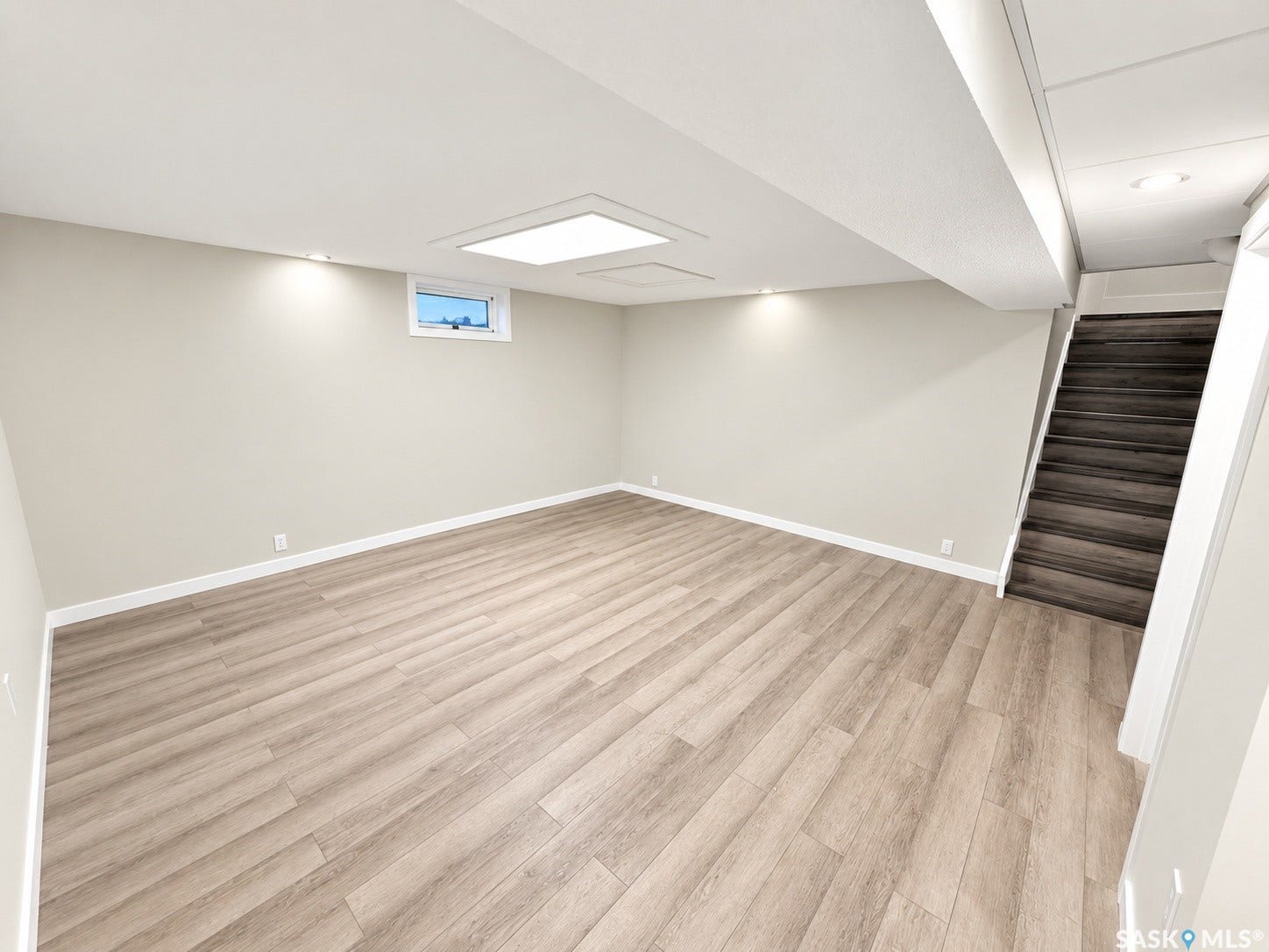 5810 Sherwood Drive, Regina SK S4T 6Y7 Recessed lighting illuminating neutral wall tones, wood-finish flooring, and a compact window