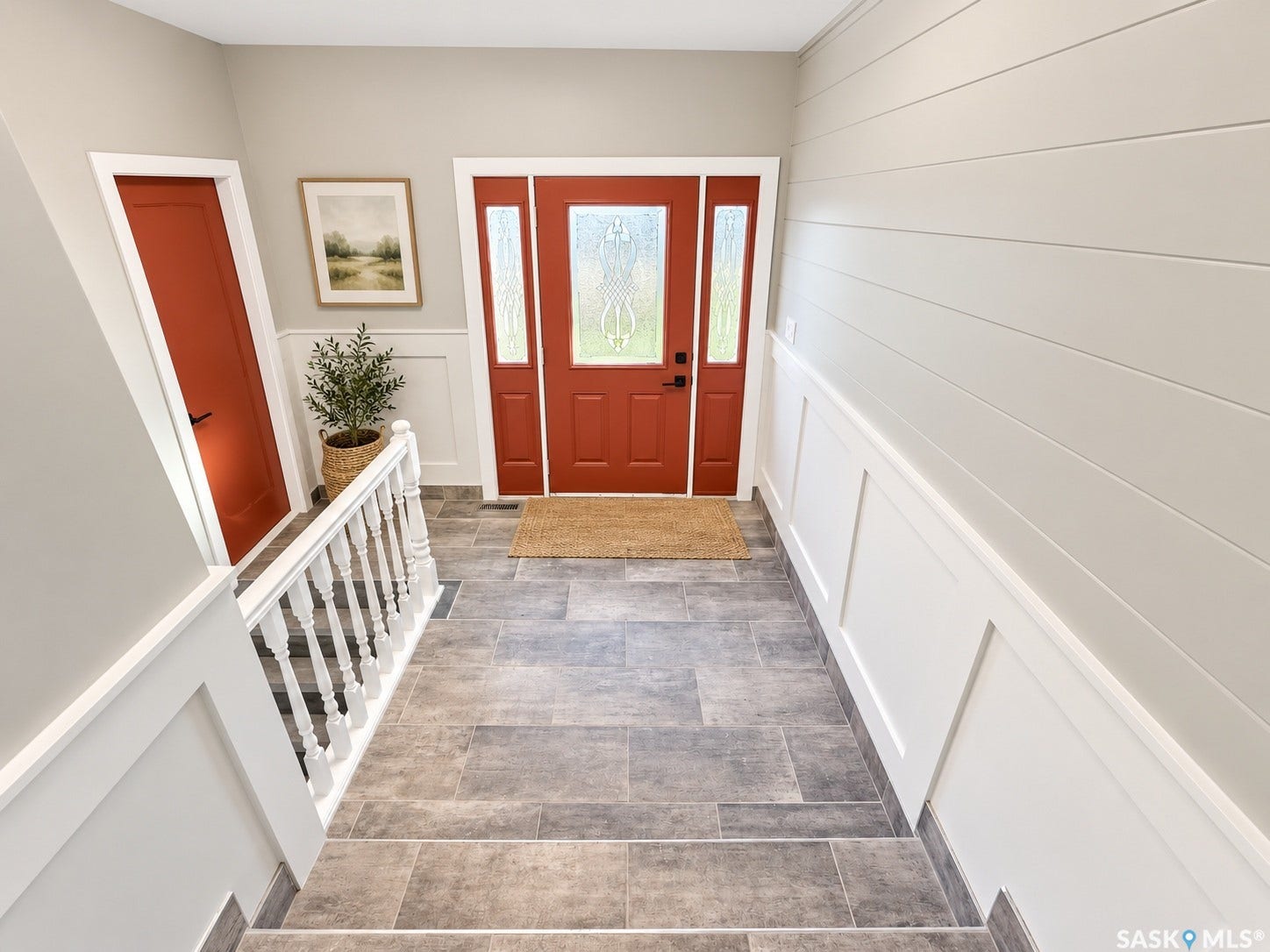 5810 Sherwood Drive, Regina SK S4T 6Y7 Entryway featuring tile flooring, white wainscoting, and a full-light front door with sidelights