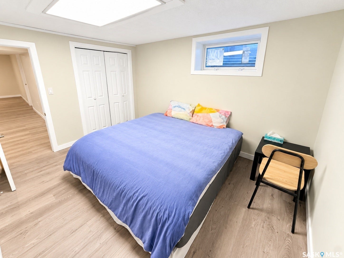 5810 Sherwood Drive, Regina SK S4T 6Y7 Wood-finish flooring, white bifold closet doors, recessed ceiling lighting, and a white-framed window