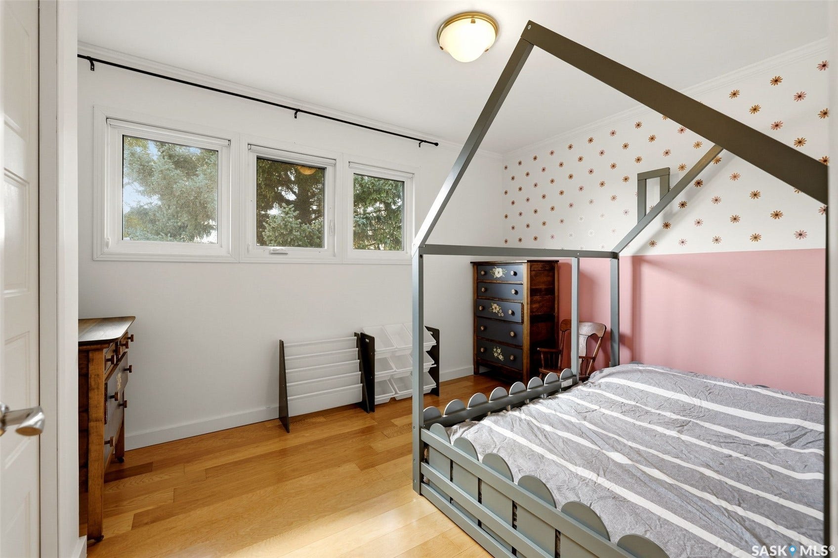 Hardwood flooring, triple windows, and a flush mount ceiling light