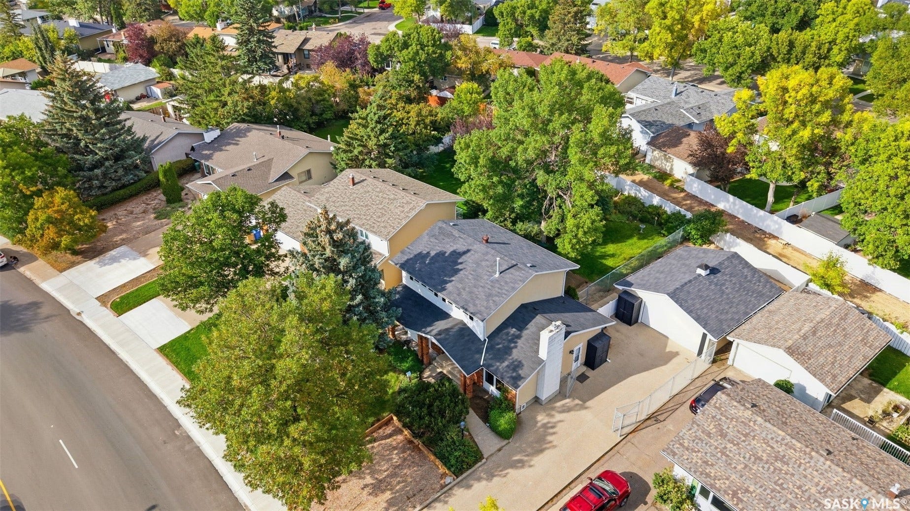 Property with a gray shingle roof, light-colored siding, and a prominent chimney feature