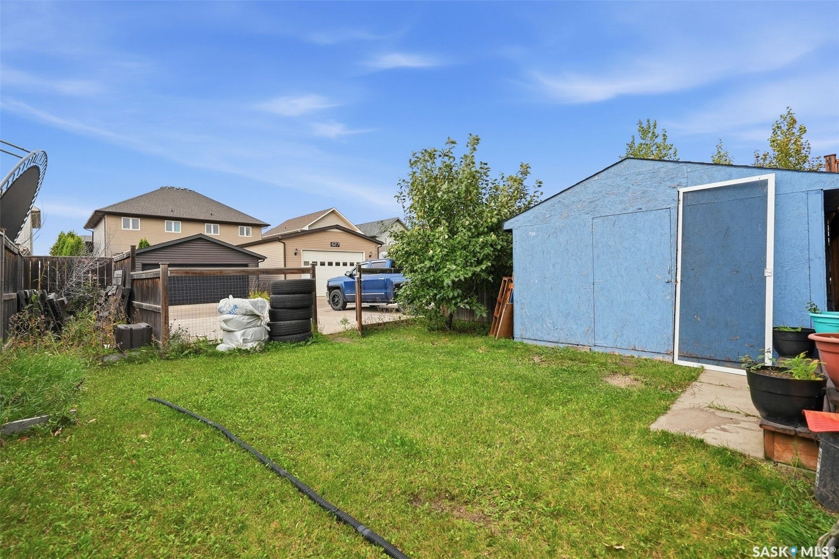 Spacious backyard with mature landscaping and established lawn area